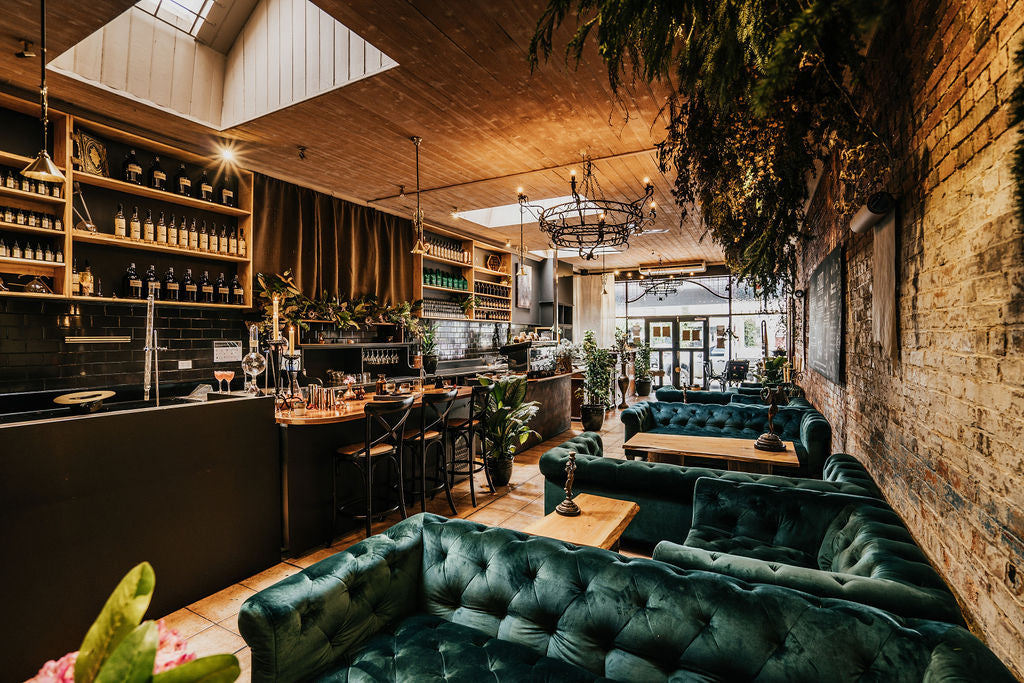 apothecary lounge with emerald velvet chesterfields