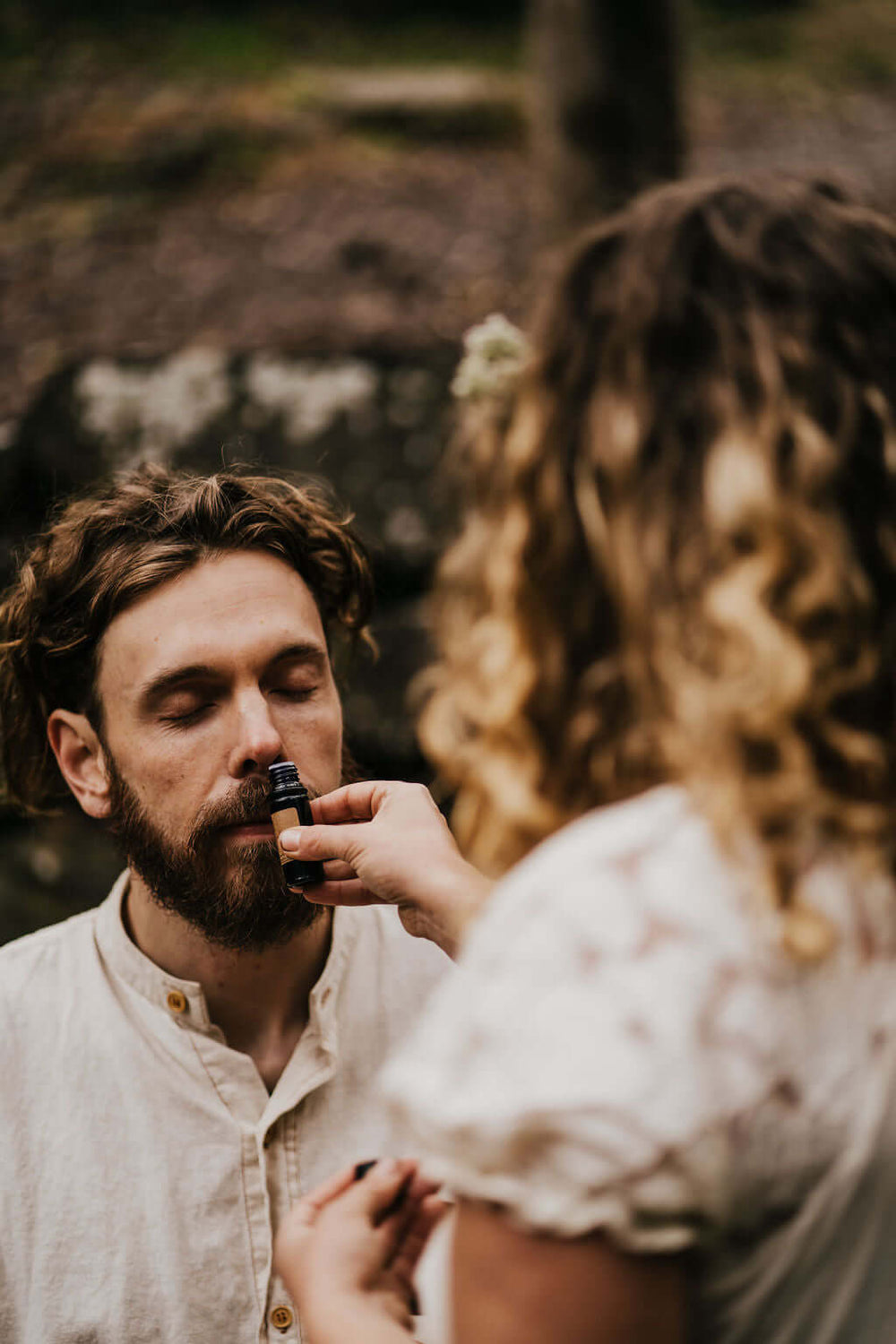 Man smelling essential oil from small vial