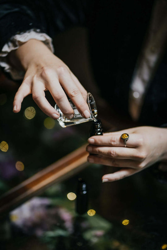 Small vial being filled with essential oil
