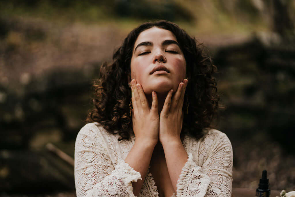 young woman holding face