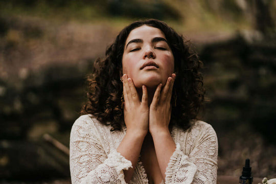 young woman holding face